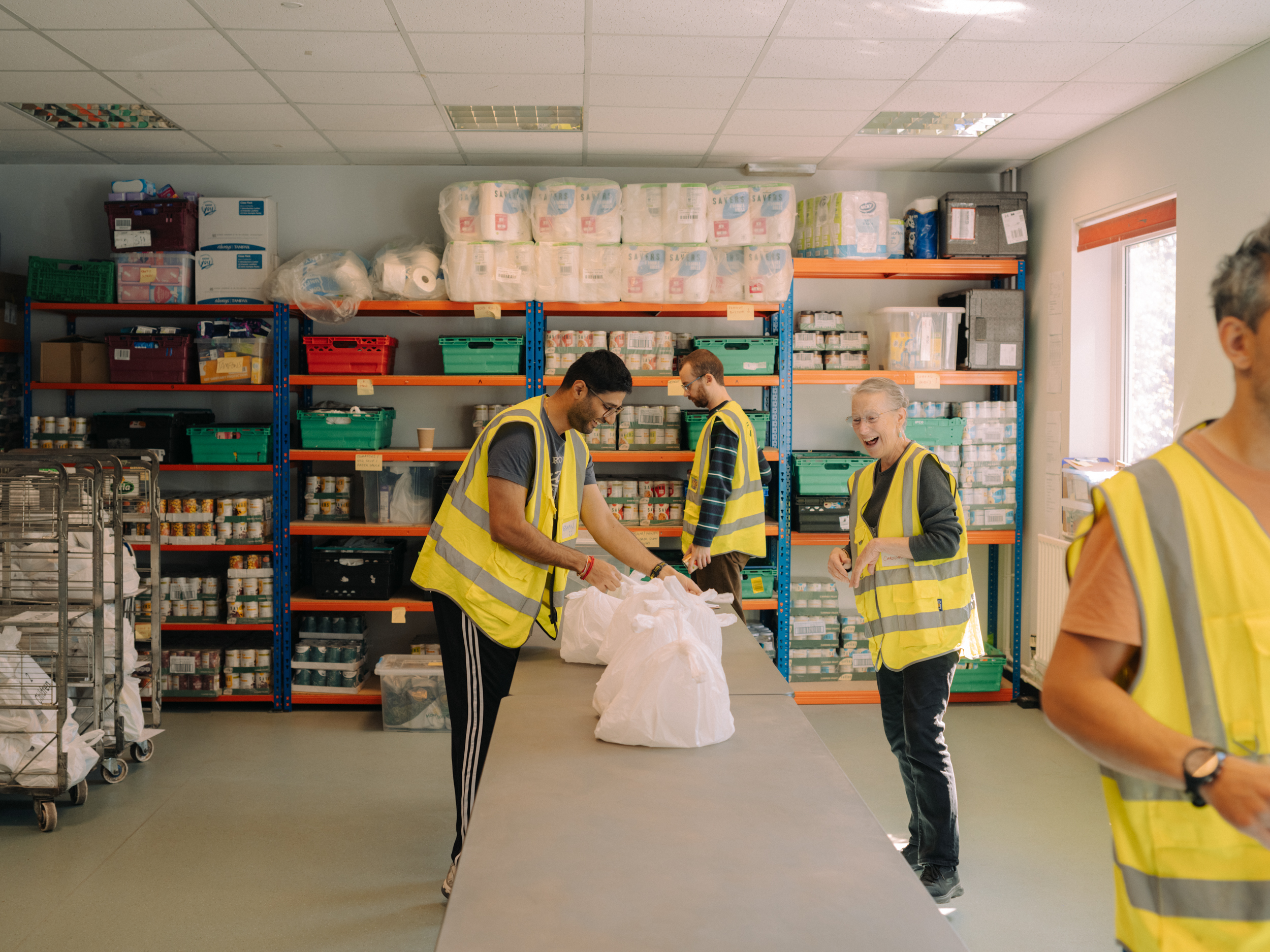 Corporate volunteer team packing food parcels at Bow Foodbank